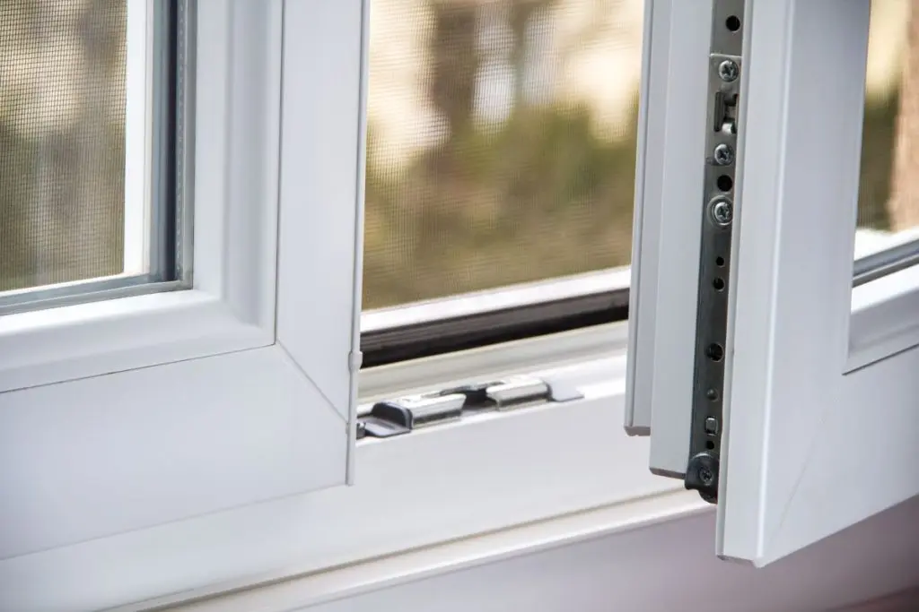 an open white window showing a mosquito net