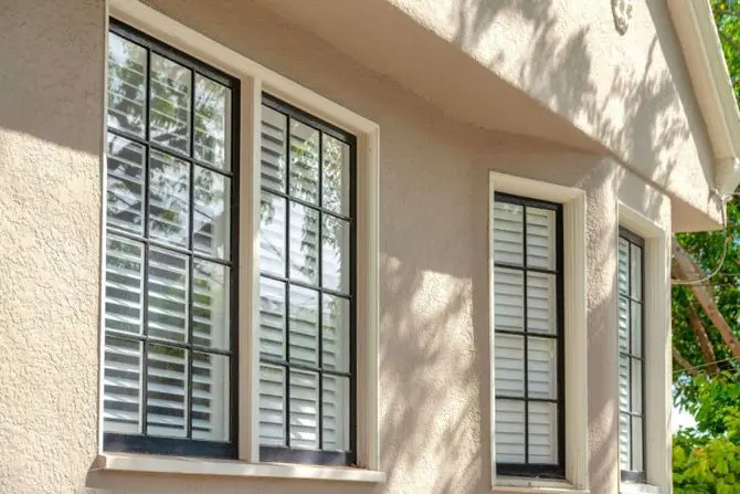beige house with black and white windows