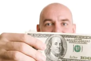 Man holding $!00 bill.
