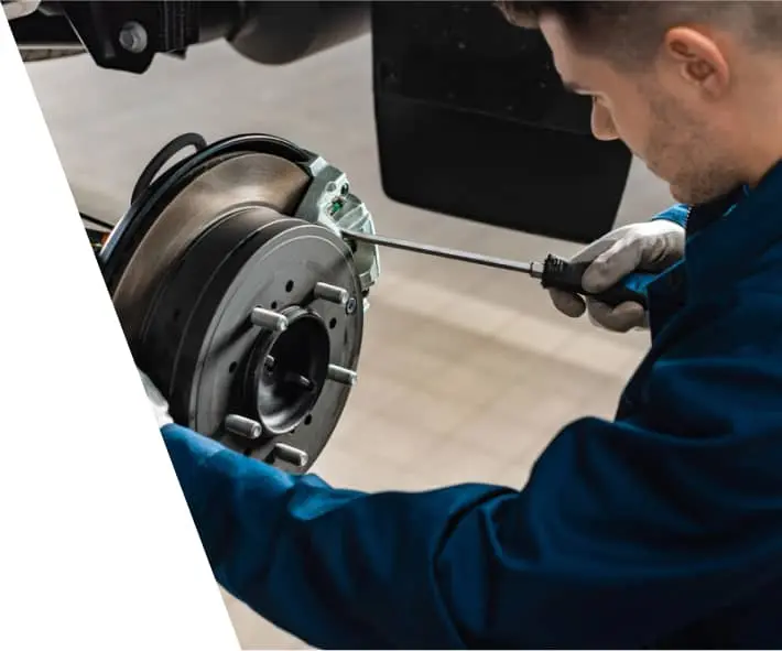 car mechanic doing a Disc Brake Assembly