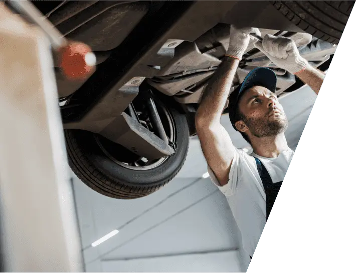 mechanic repairing a transfer case of car