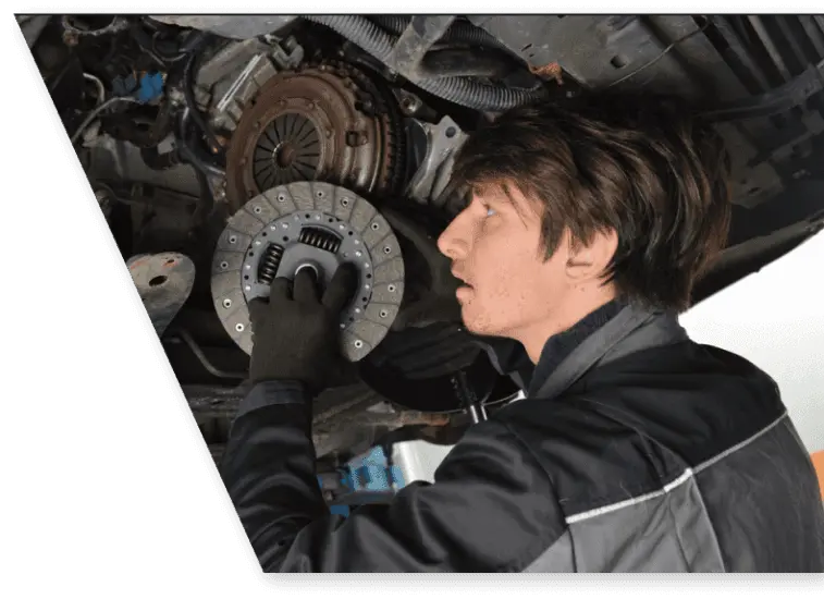 auto mechanic replacing a car clutch