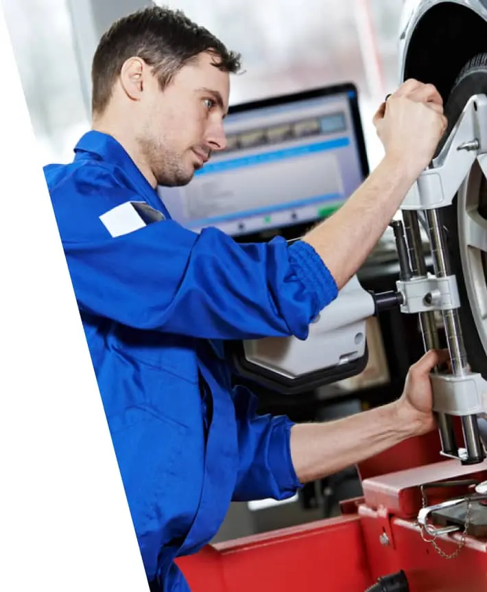 img - auto-mechanic-at-wheel-alignment-work-with-spanner