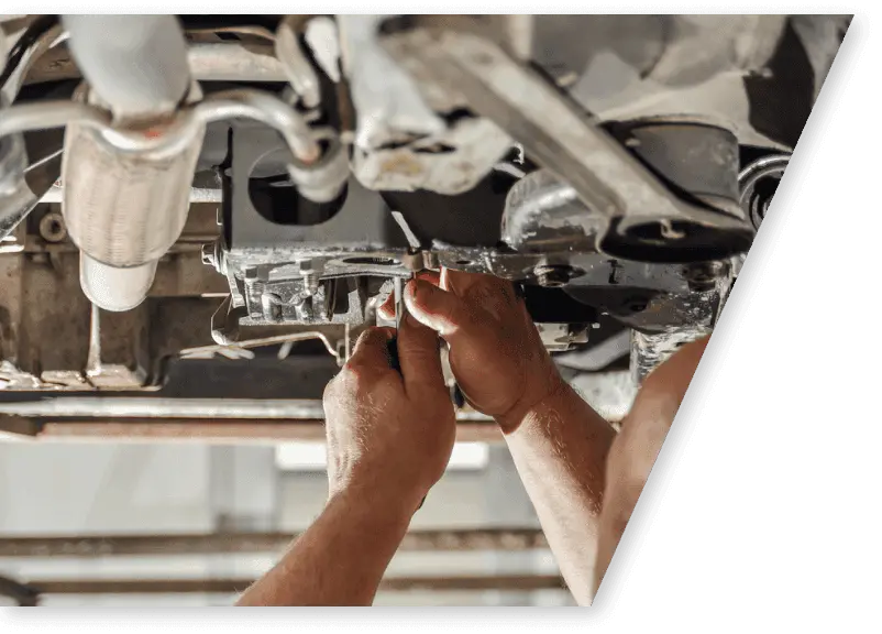 car mechanic repairing chassis of a car on a standing lift