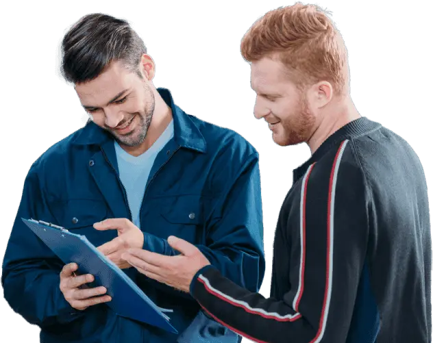 male car mechanics looking at a clipboard