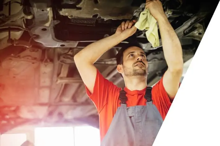 car mechanic fixing a car under