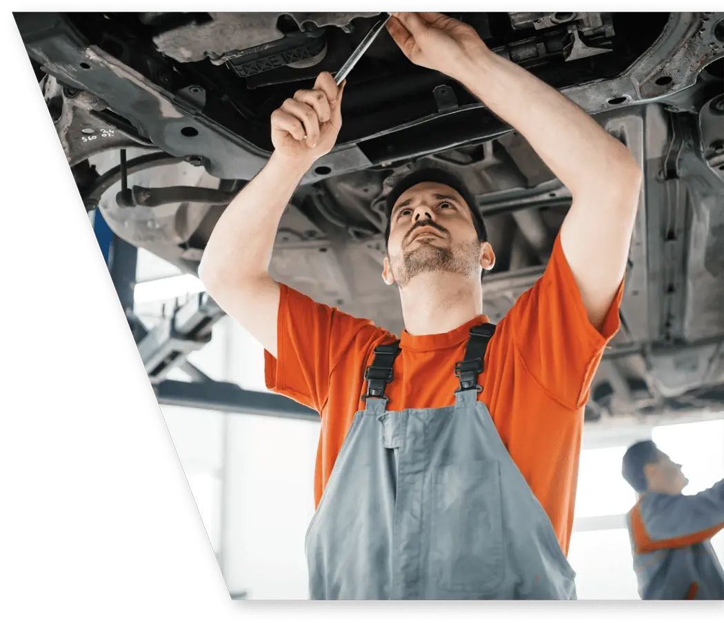 mechanic working on transmission rebuild on a Nissan