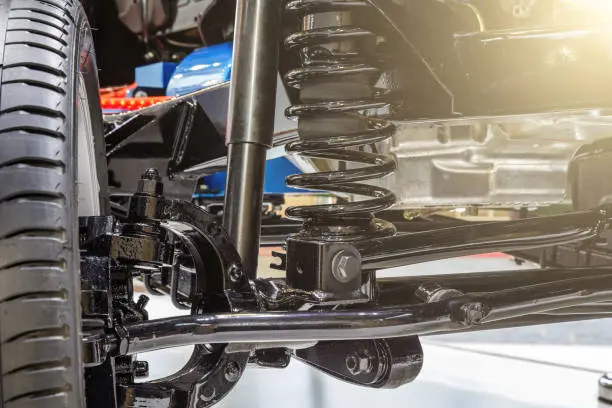 Front axle with suspension and absorber.
