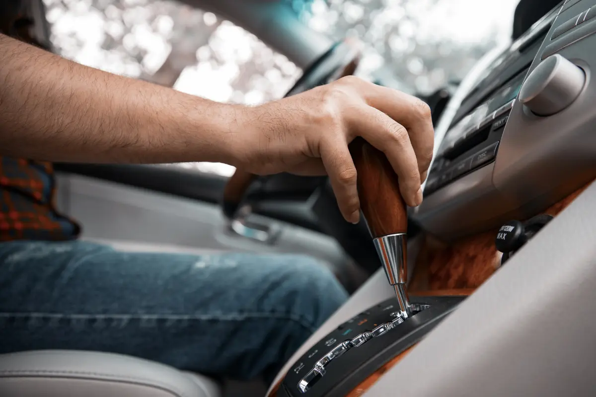 Persons hand on the transmission