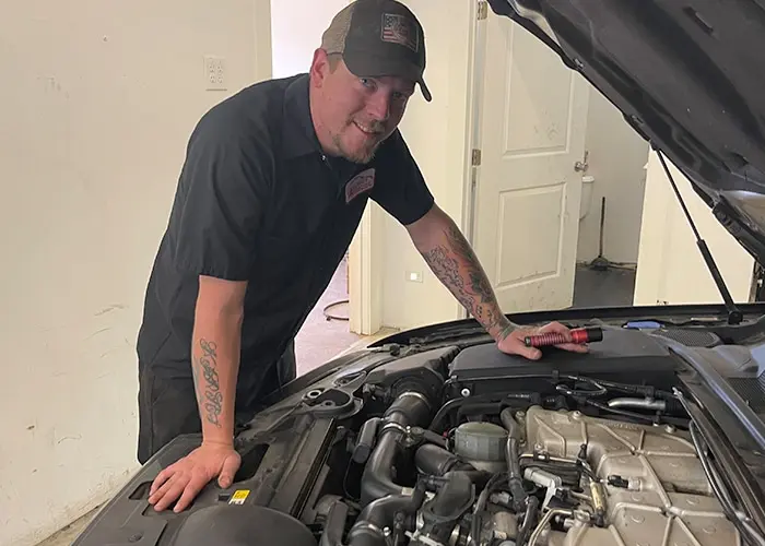 A technician conducting maintenance and repairs on a car engine.