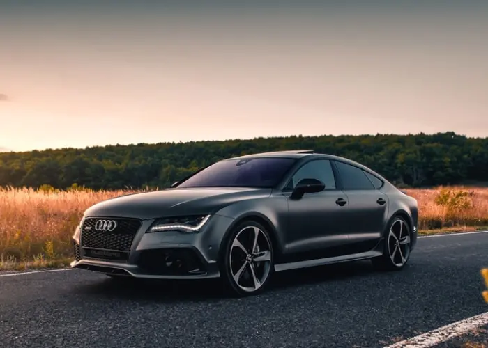 Image of brand new Audi gray sedan driving on the road in Northglenn, Co for Audi maintenance and repair.