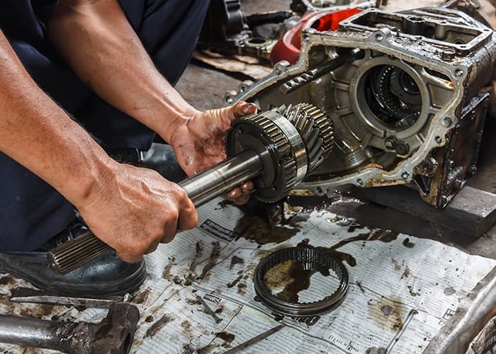 A close-up view of a car's transmission system, featuring gears and mechanical components