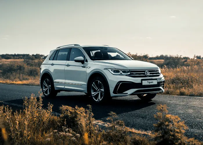 Image of brand new Volkswagen Tiguan driving on road in Northglenn, Co for VW maintenance and repair.