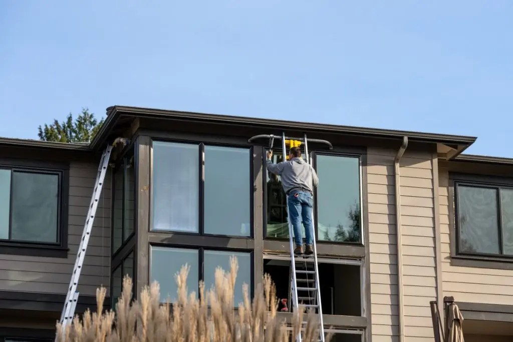 guy installing big windows