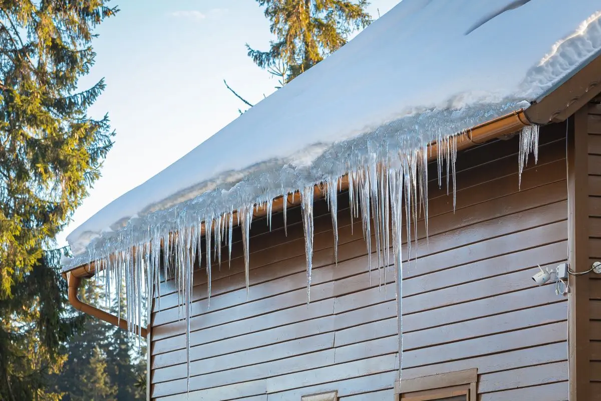 ice dam removal parma oh snow on top of roof brown siding house