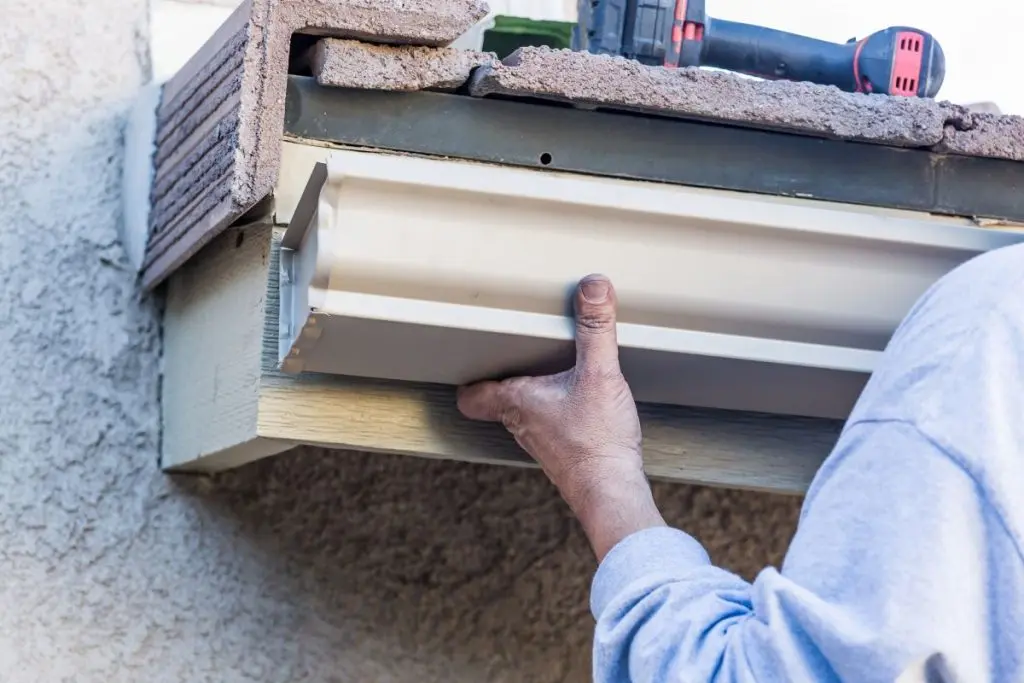 guy installing new gutter