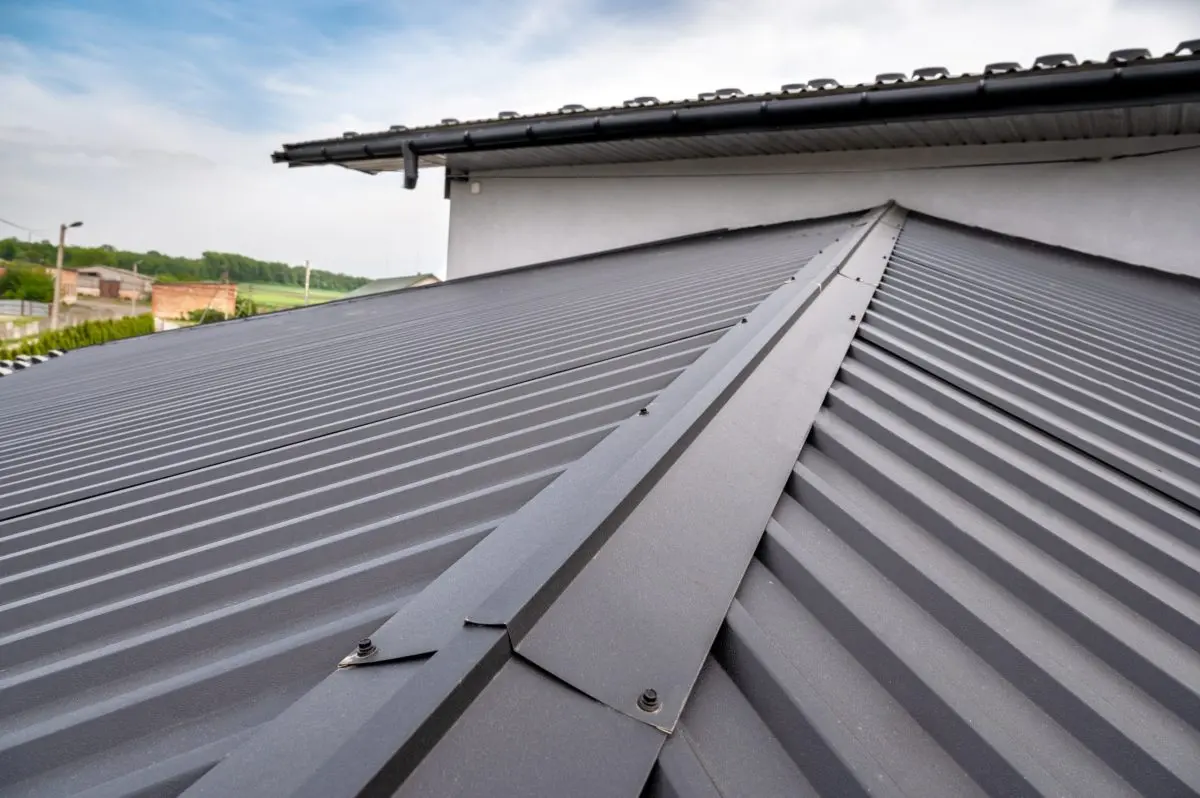 corrugated metal roofing Gutter system for a metal roof. Holder gutter drainage system on the roof.
