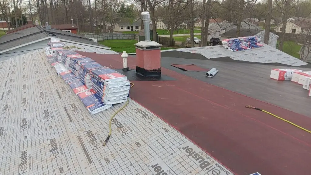 Roofing materials sitting on a roof in the middle of repair