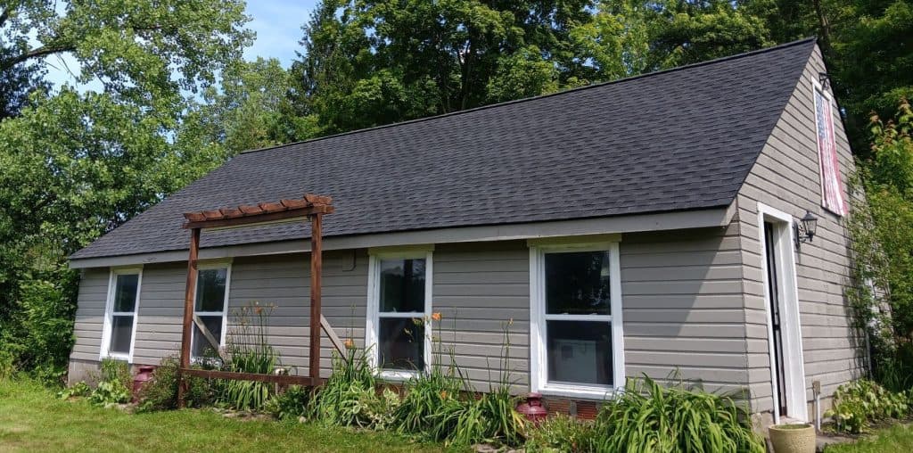 beige siding black shingles roof
