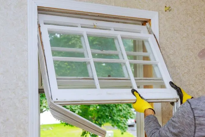 raleigh nc window installers worker repairing old damaged window white frame family house