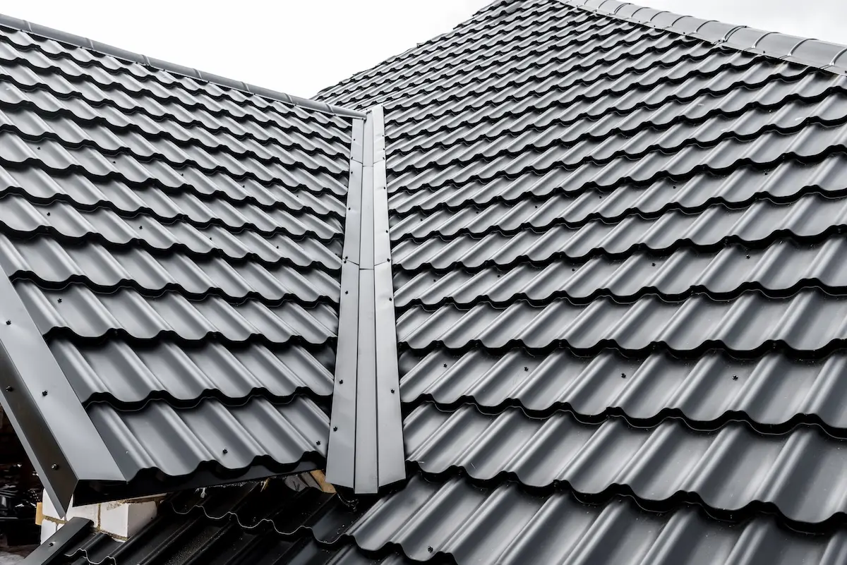 Construction of the roof of the house. Metal tiles.