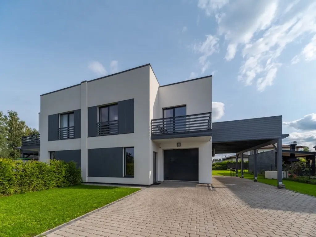 roof types Exterior of modern luxury private house. Garage entrance. Canopy. Blue sky. Sunny day.