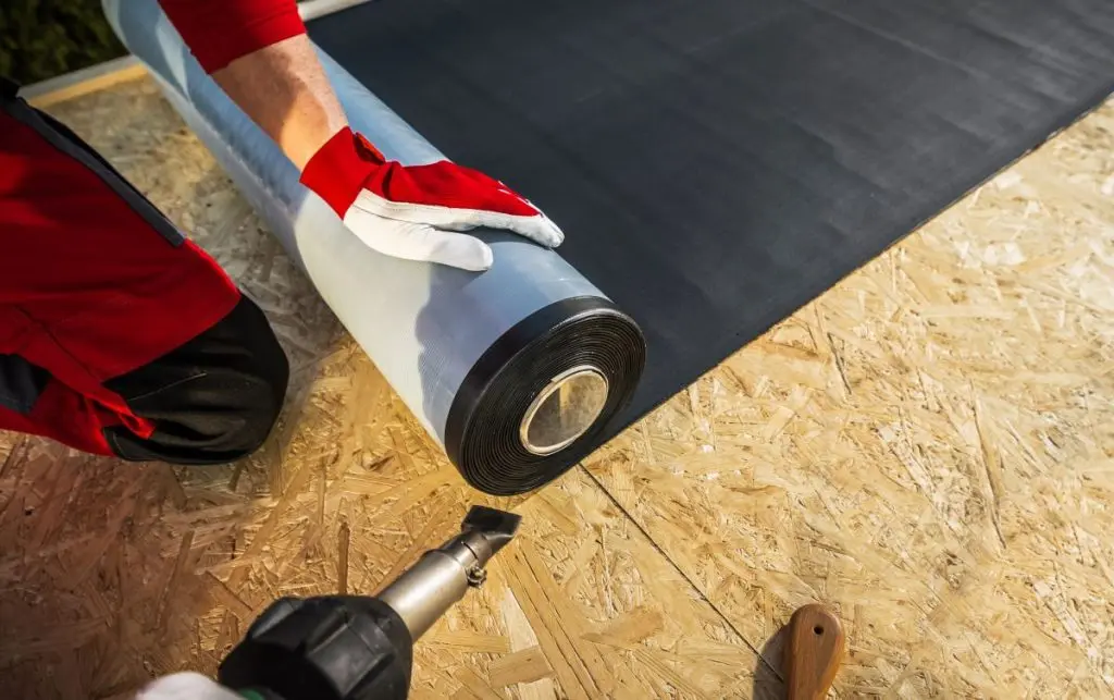 worker holding epdm roller