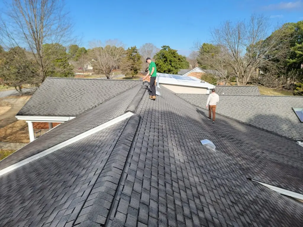 best roofing companies in wake forest nc two men on top of shingles roof