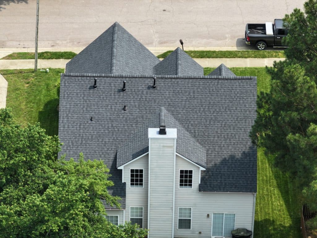 aerial view of small house with shingles roof