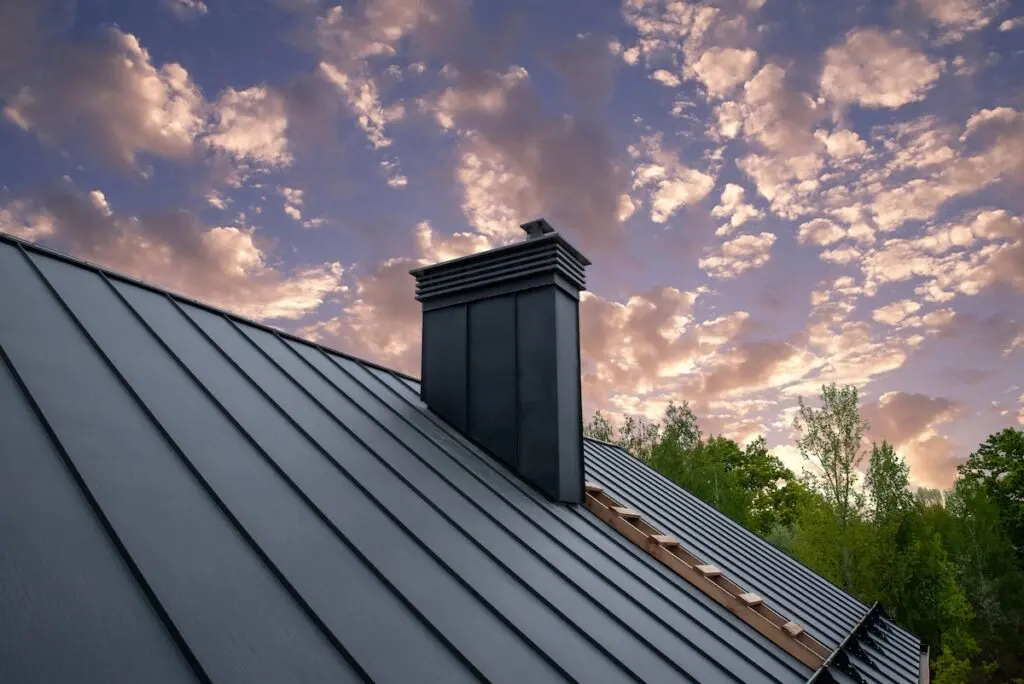 Modern metal chimney on the roof for ventilation how long does a metal roof last