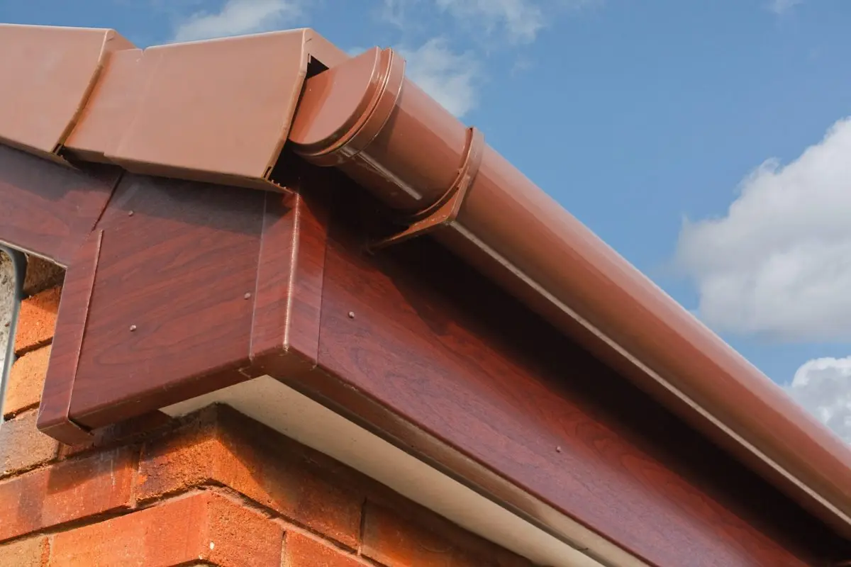 gutters cary nc close up of Brown wood effect PVCu or plastic soffit, fascia and guttering on modern new build residential property