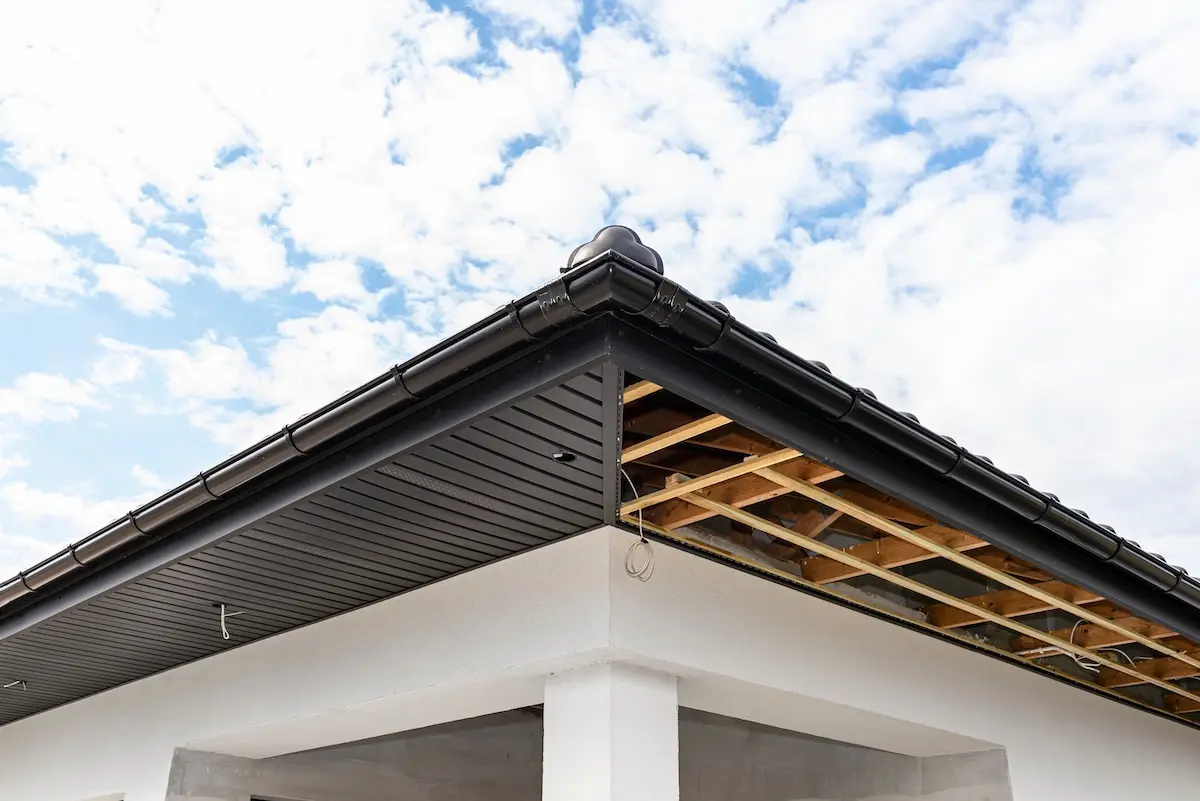 Scaffolding with three rows of wooden battens and a modern graphite soffit made in half, visible H and J slats.