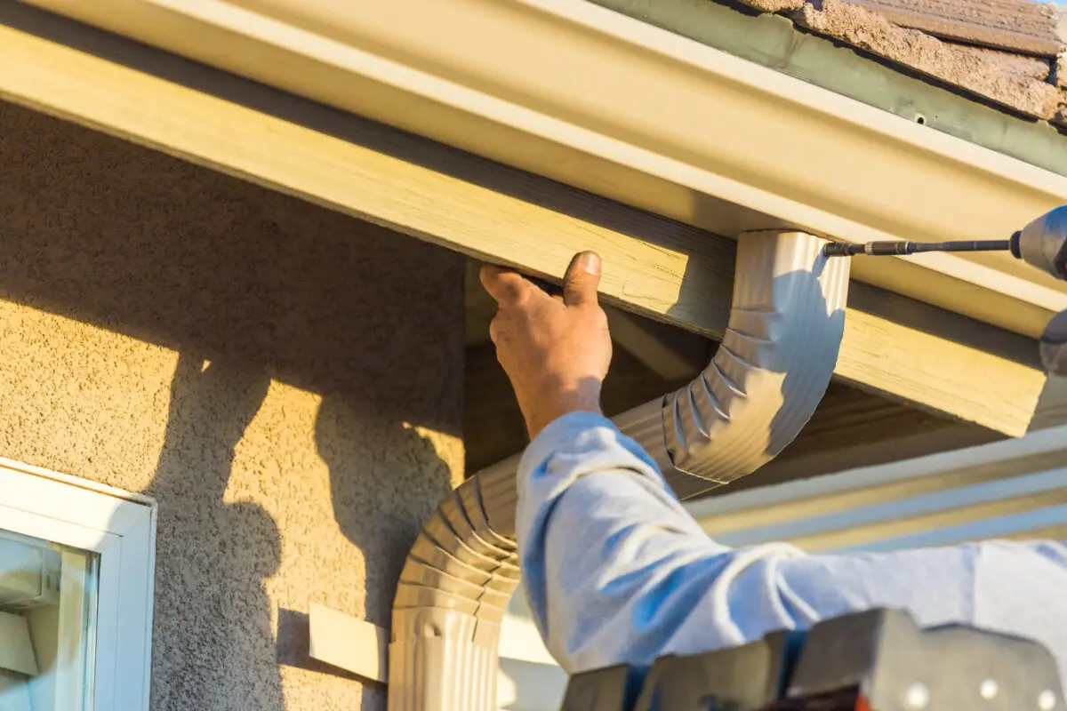 Worker Attaching Aluminum Rain Gutter