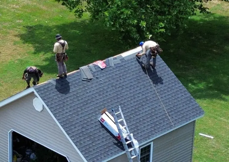 Grand Exteriors team installing shingles