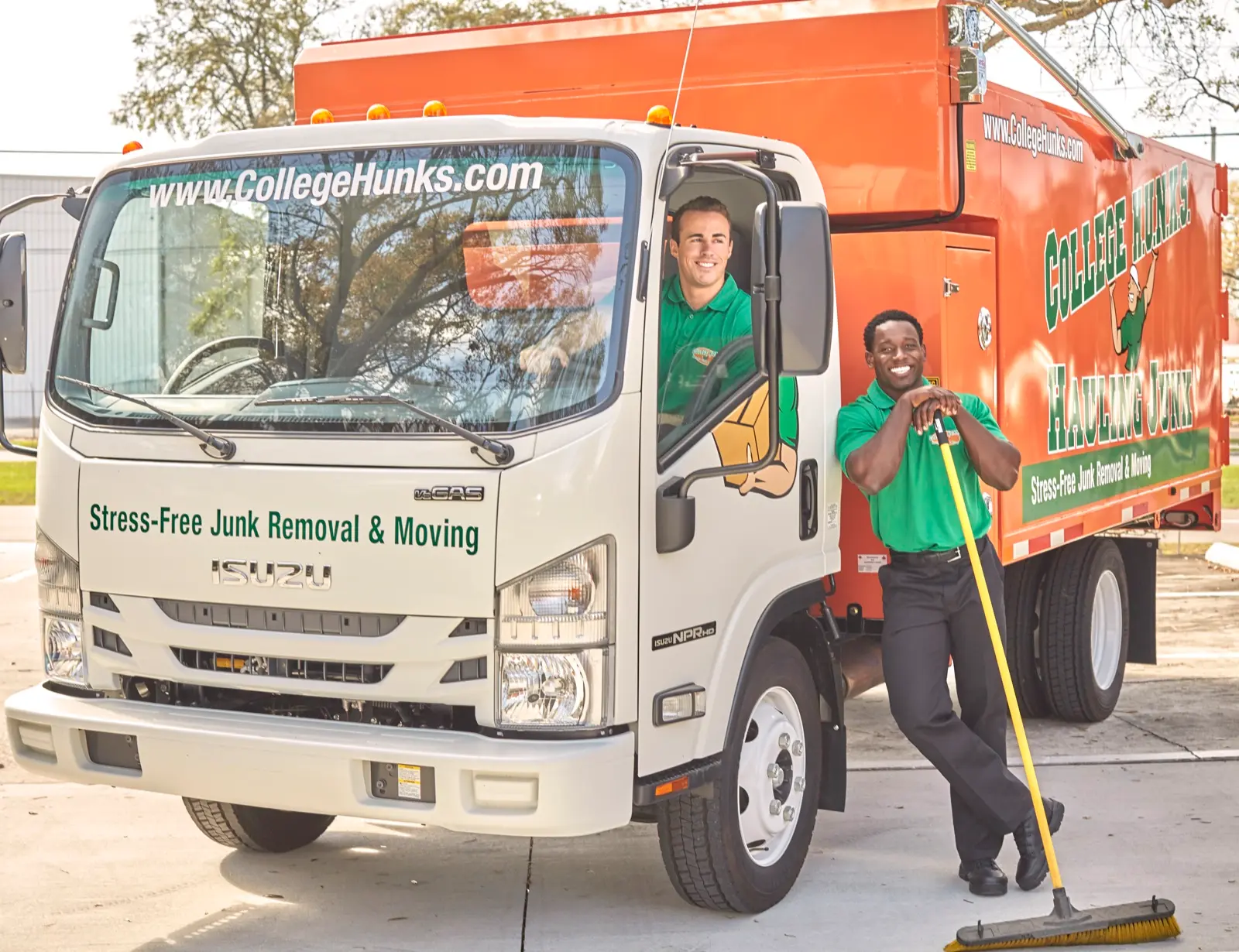 Two College HUNKS crew members with a branded junk removal truck