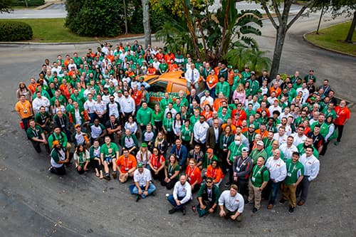 Aerial photo of hundreds of College HUNKS franchisees and staff gathered outside at the annual reunion