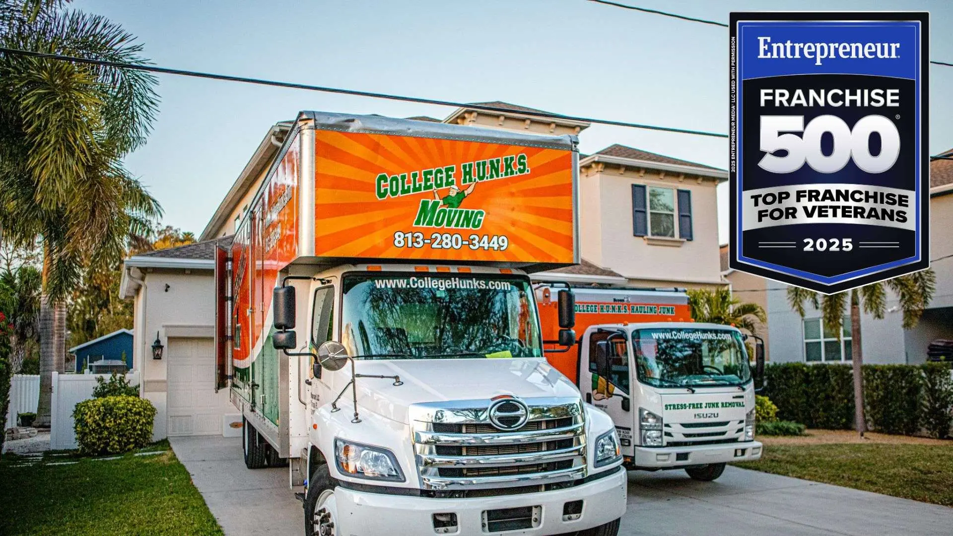 Two orange and white College HUNKS Moving trucks parked outside a home