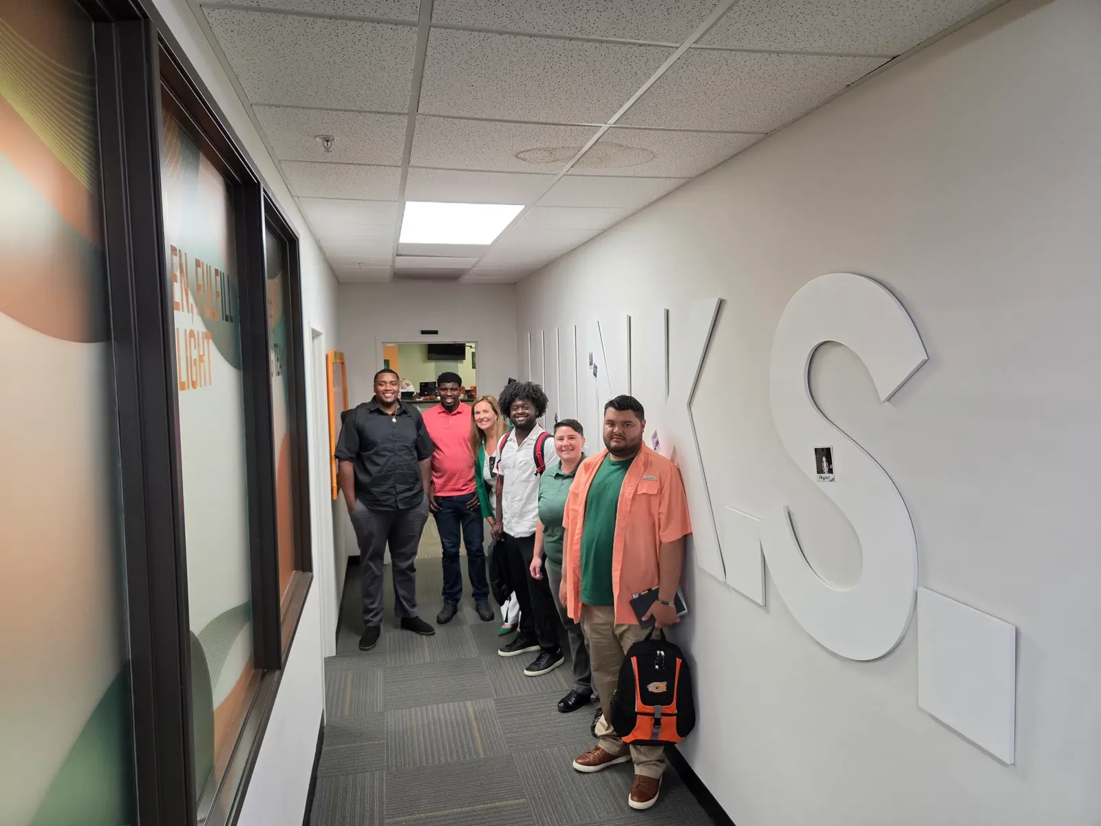 Franchise candidates and College HUNKS team members together during a discovery day visit at the corporate office