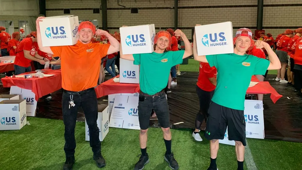 College HUNKS team members serving the community at a U.S. Hunger meal-packing event