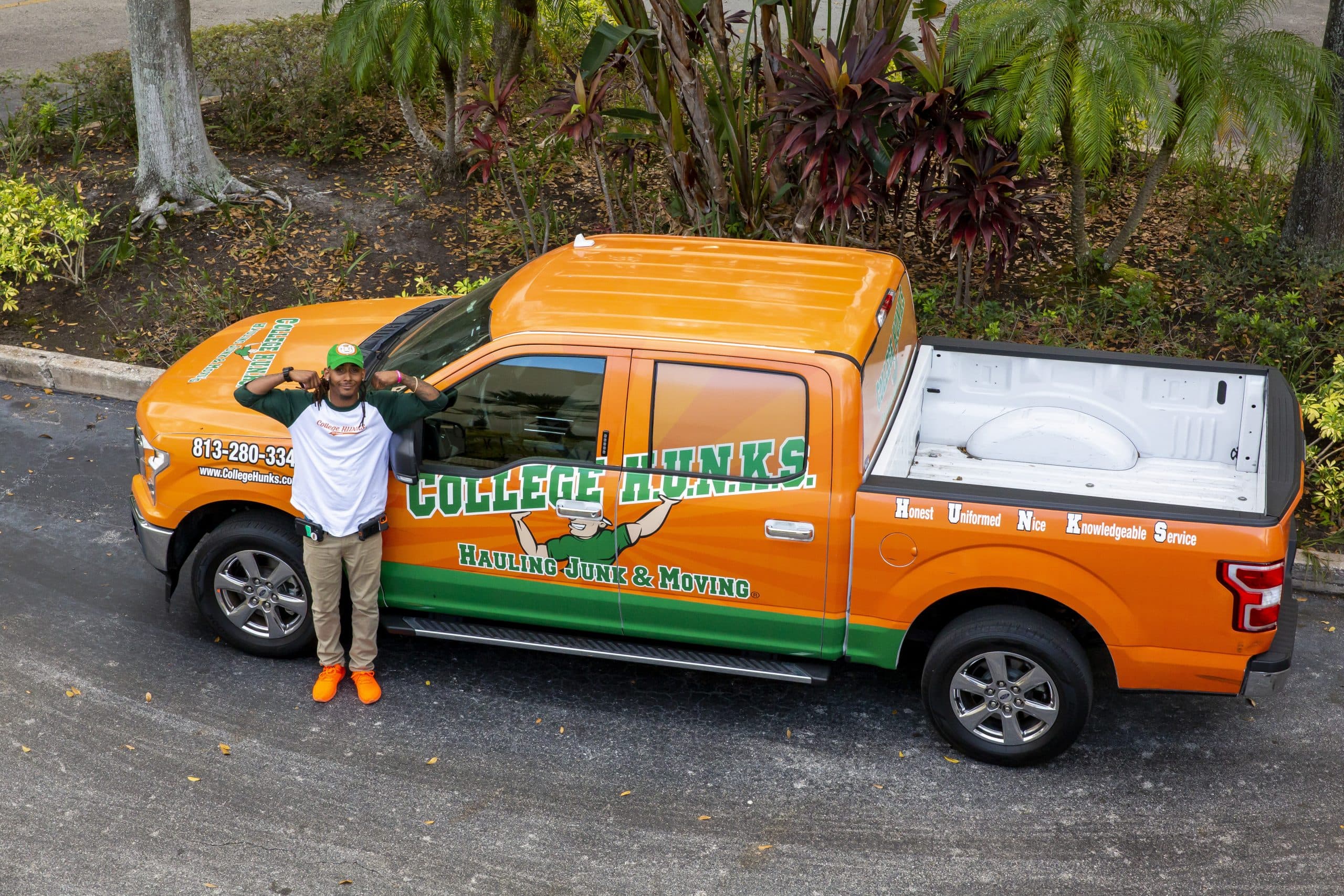 A College HUNKS franchise owner beside a branded pickup truck, the kind of local service business veterans start