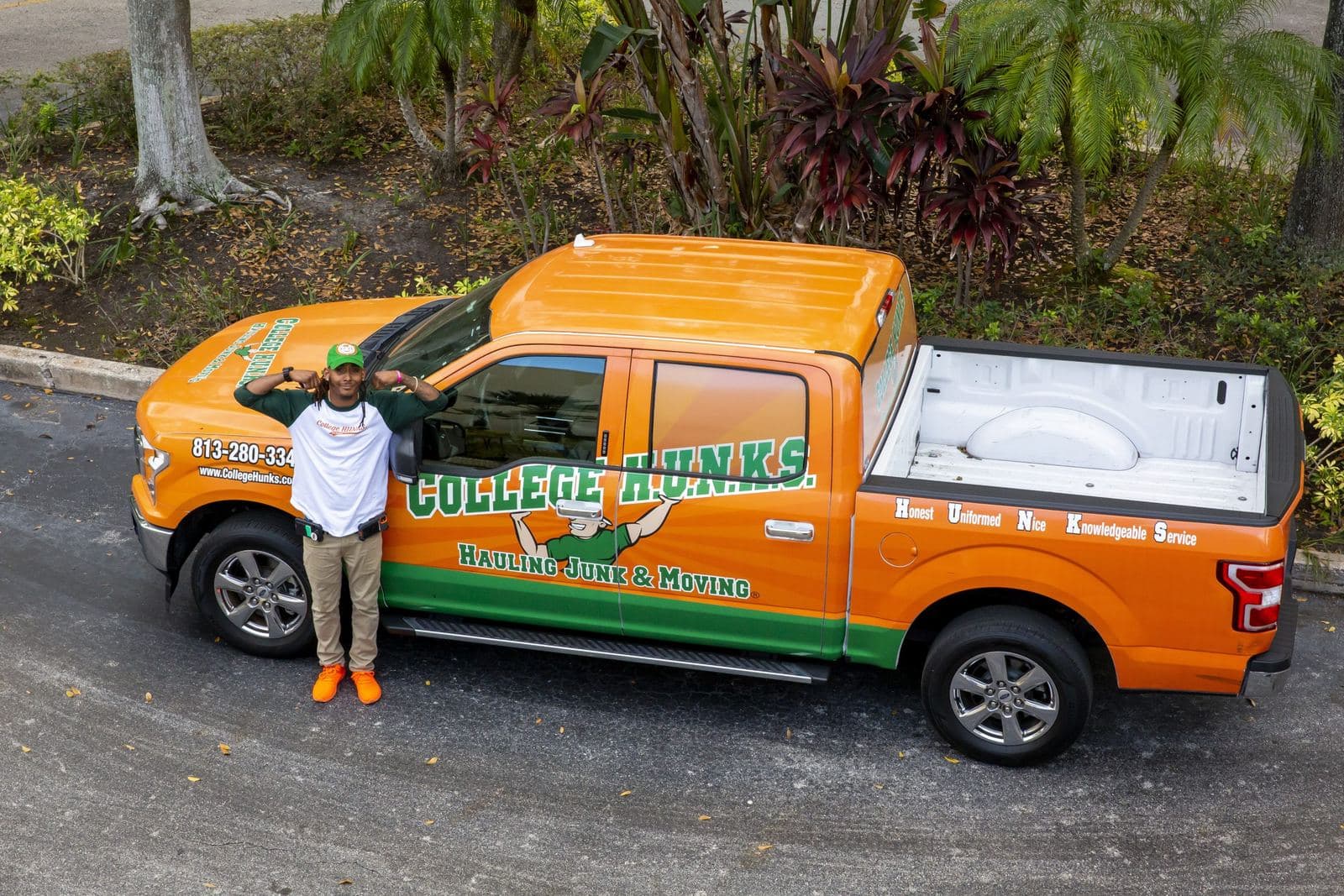A College HUNKS franchise owner beside a branded pickup truck, the kind of local service business veterans start