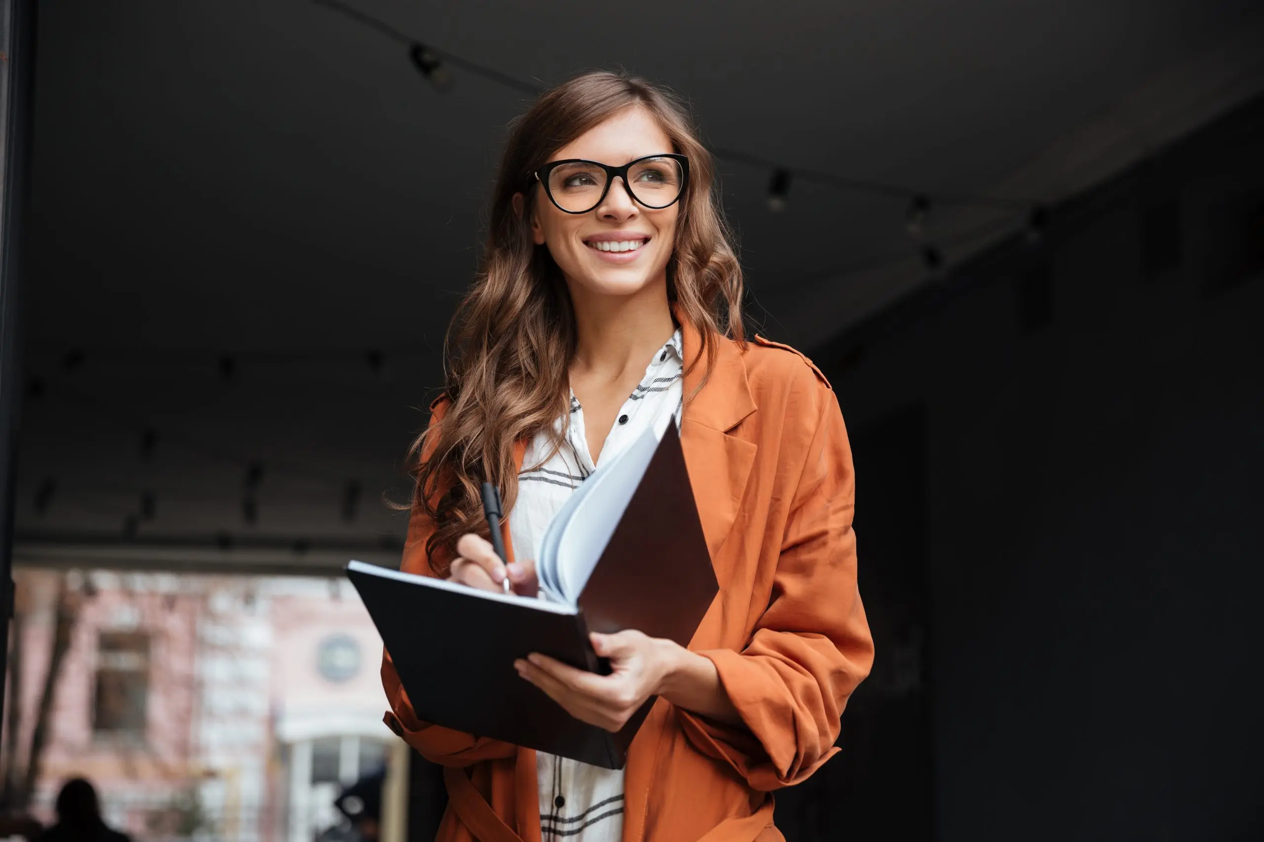 A professional reviewing notes in a planner, mapping out what to do after getting laid off