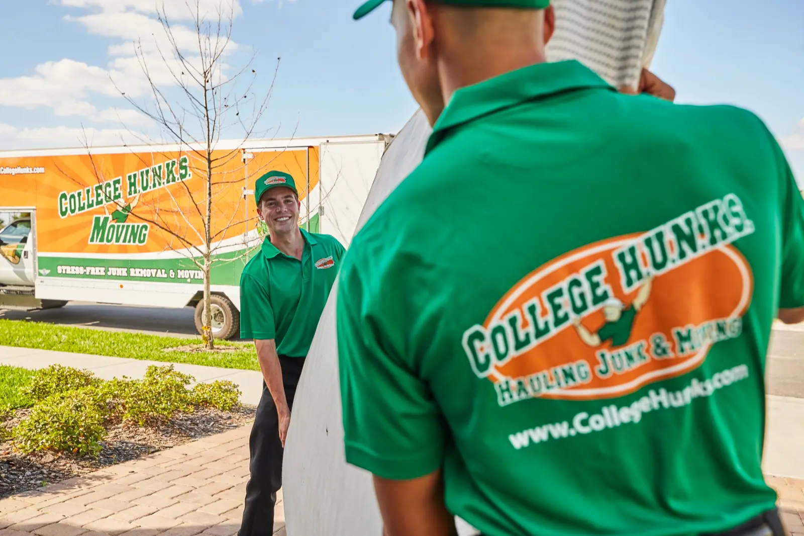 Franchise crew loading furniture into a branded truck, the day-one operation a franchise buyer inherits instead of building