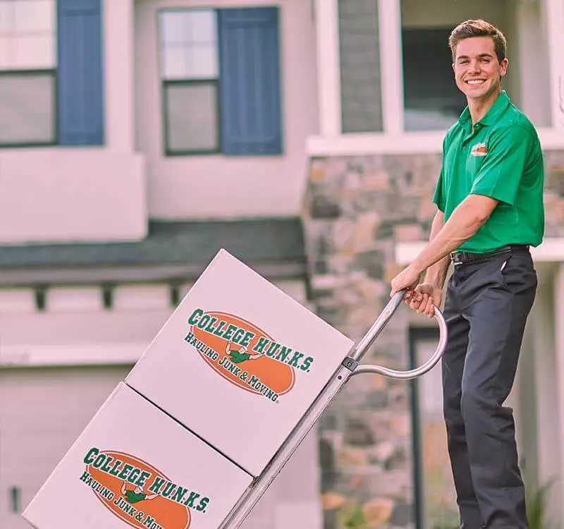 College HUNKS crew moving branded boxes, the independent operation behind a franchise conversion