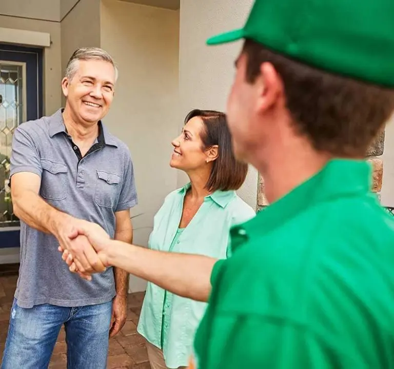 College HUNKS crew member shaking hands with customers, the owner-operator relationship a master franchise agreement replaces