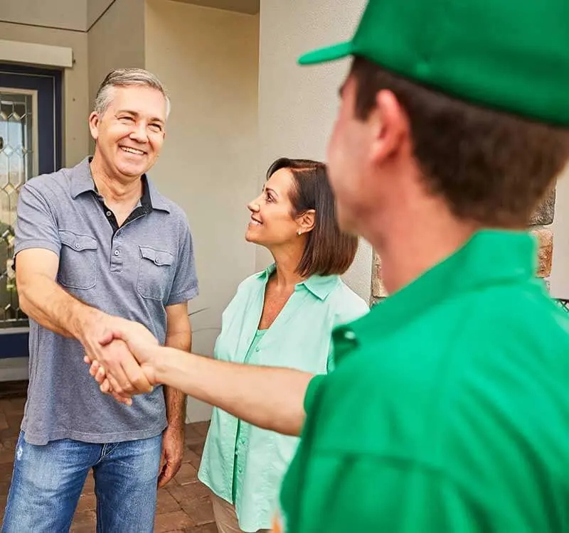 College HUNKS crew member shaking hands with customers, the owner-operator relationship a master franchise agreement replaces