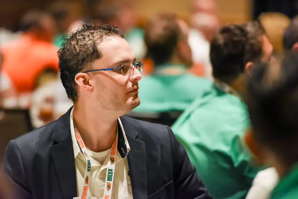 Franchisee listening to a speaker at the College HUNKS annual conference