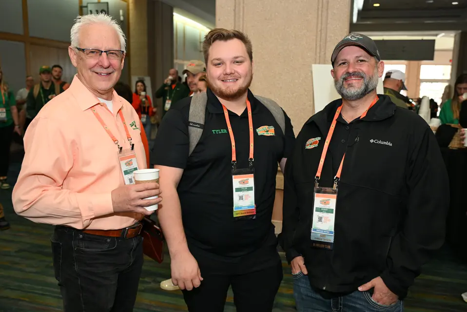 Three franchise owners networking over coffee at the conference