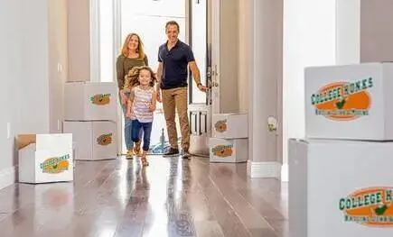 Family walking into their new home with College HUNKS moving boxes