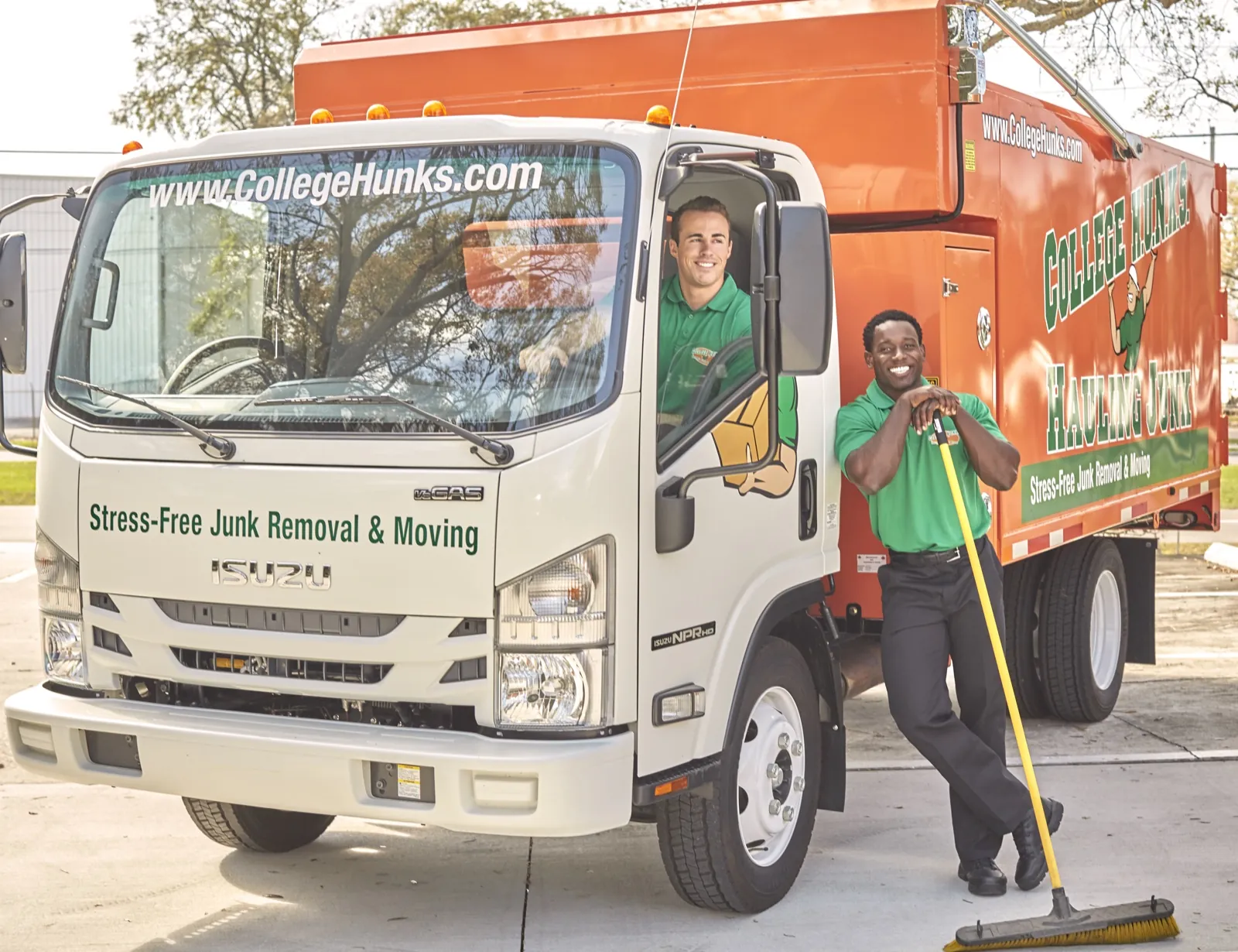 Two College HUNKS crew members with a branded junk removal truck